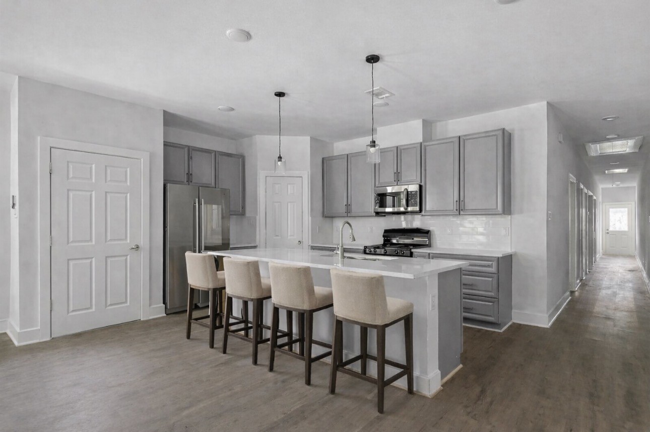 6010 Bobby Burns Street Houston, TX 77028 - Photo 5 of 22 a kitchen with kitchen island a dining table chairs sink and cabinets