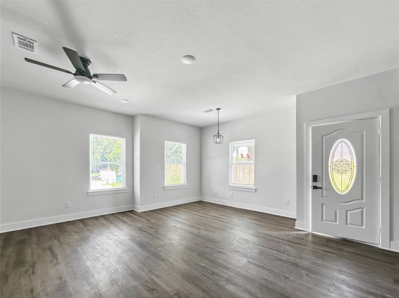 6010 Bobby Burns Street Houston, TX 77028 - Photo 10 of 22 a view of an empty room with a window and wooden floor