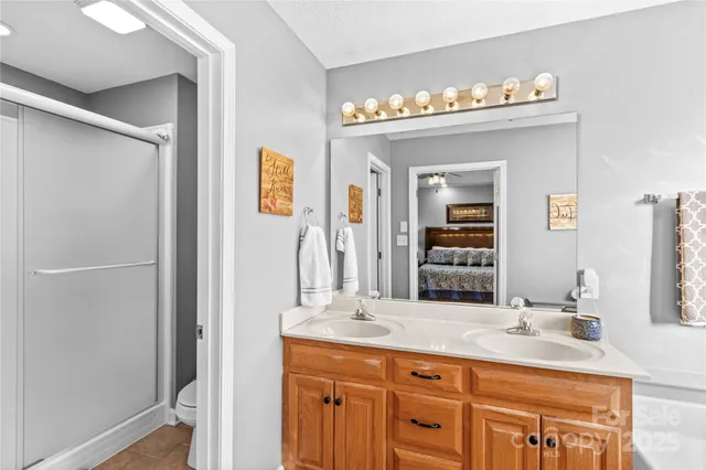a bathroom with a double vanity sink and a mirror