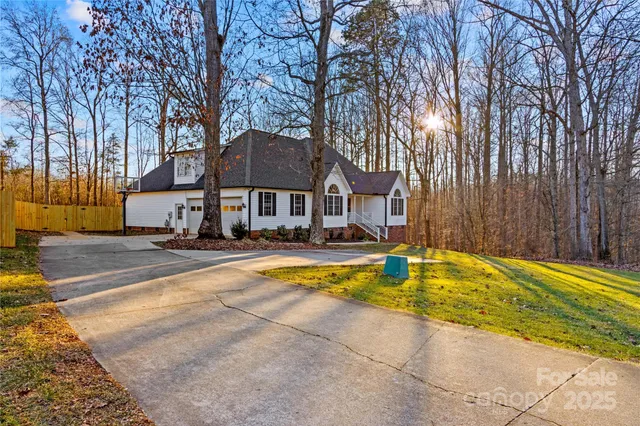 a view of a swimming pool in the backyard of house with outdoor seating