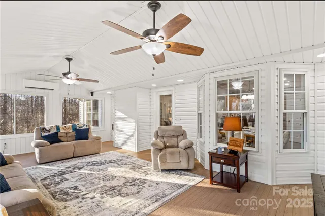 a living room with furniture ceiling fan and a rug