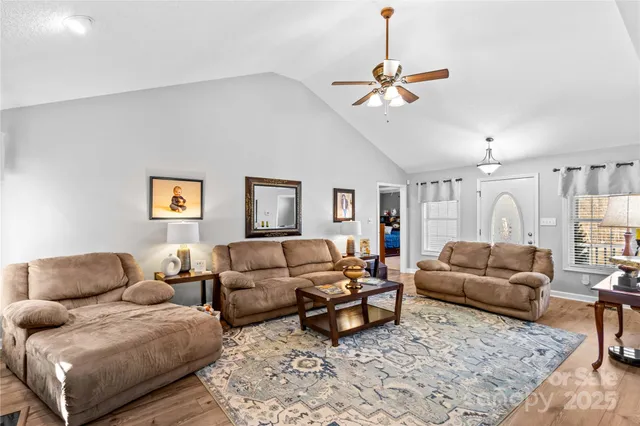 a living room with furniture and a ceiling fan