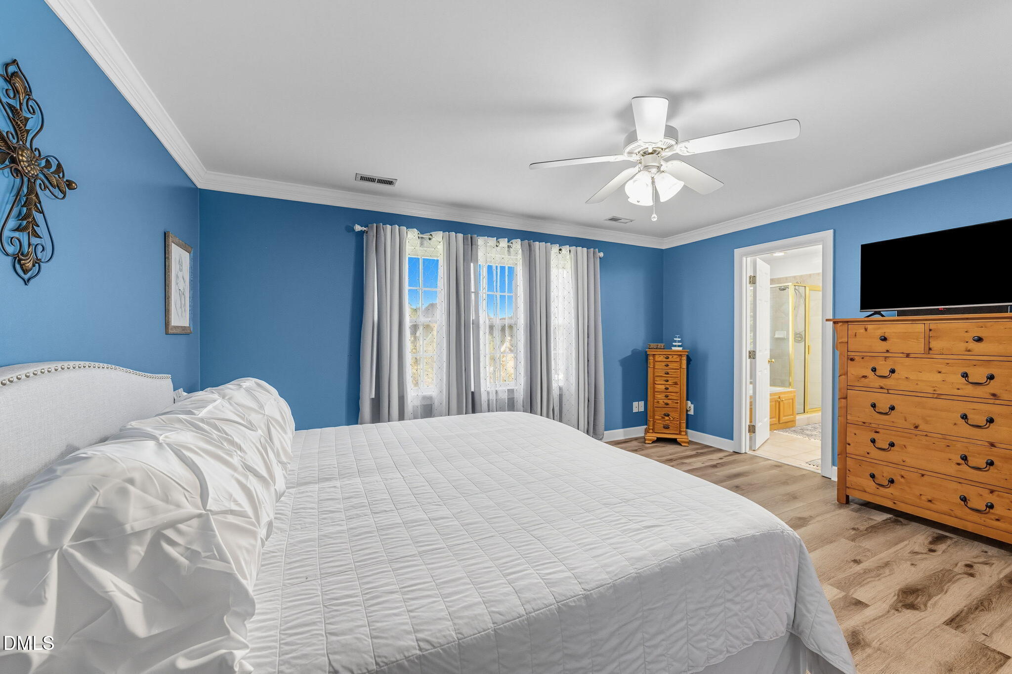 1617 Kendall Hill Road Willow Spring, NC 27592 - Photo 44 of 58 a bedroom with a bed a dresser and a flat tv screen