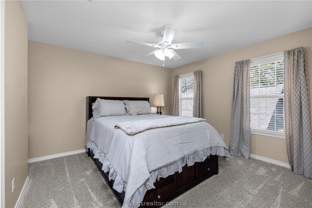 6400 Koppe Bridge Road College Station, TX 77845 - Photo 32 of 47 Upstairs bedroom featuring a ceiling fan and light carpet.