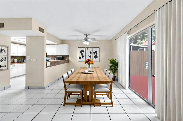 a view of a dining room with furniture and chandelier