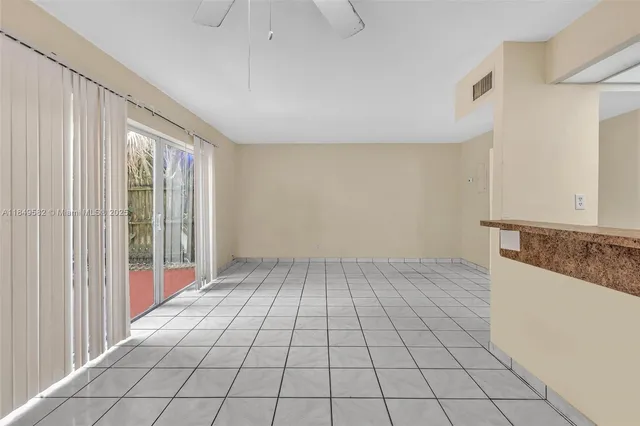 a view of a kitchen with kitchen island granite countertop a refrigerator and a sink