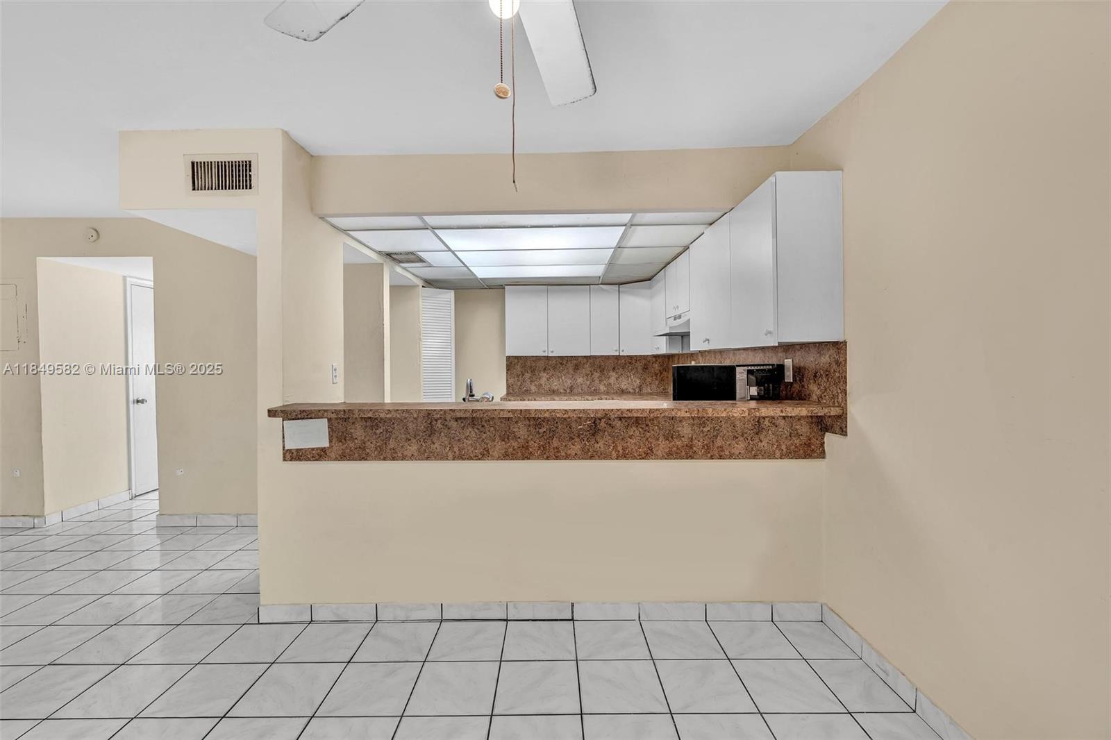 3750 Southwest 60th Terrace, Unit 1 Davie, FL 33314 - Photo 19 of 56 a view of a kitchen with kitchen island granite countertop a refrigerator and a sink