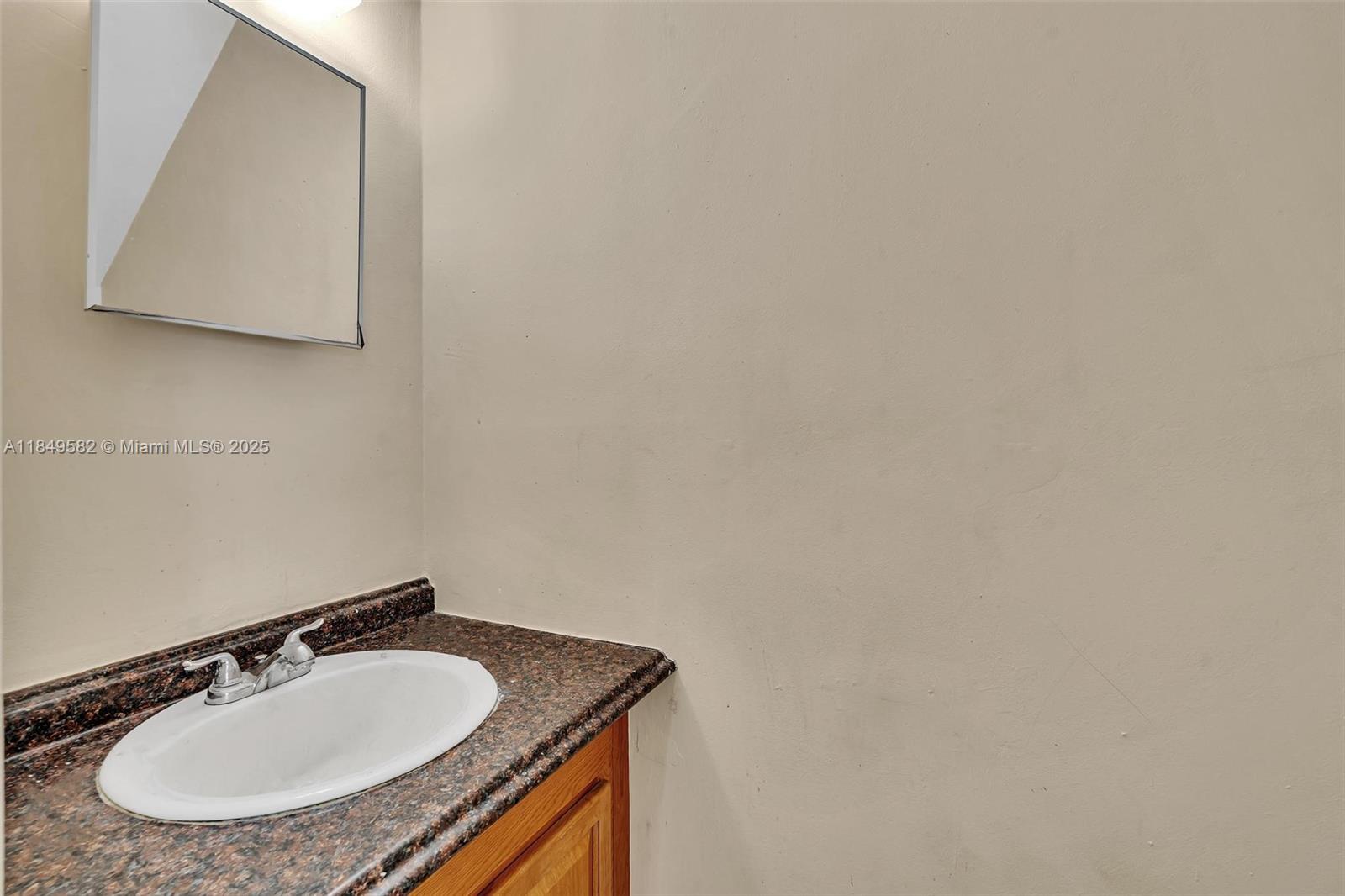 3750 Southwest 60th Terrace, Unit 1 Davie, FL 33314 - Photo 26 of 56 a bathroom with a sink and a mirror