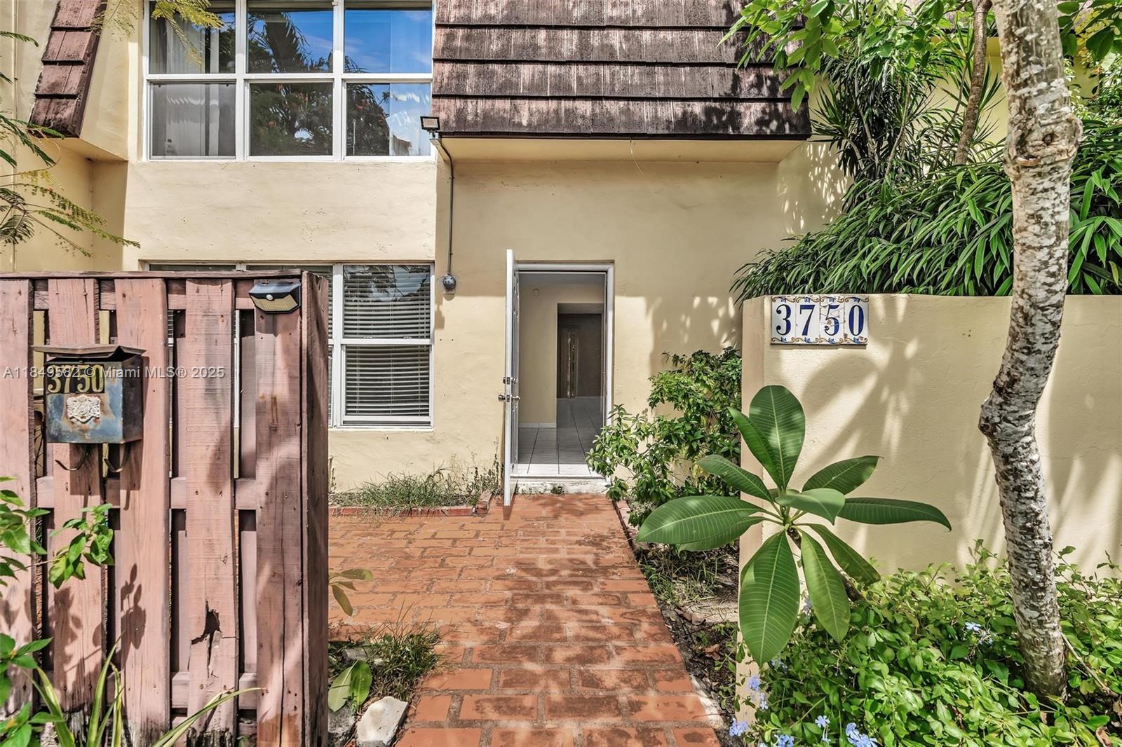 3750 Southwest 60th Terrace, Unit 1 Davie, FL 33314 - Photo 3 of 56 a view of a street with potted plants