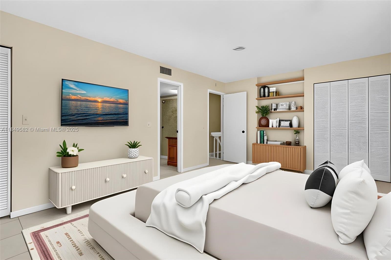 3750 Southwest 60th Terrace, Unit 1 Davie, FL 33314 - Photo 32 of 56 a bedroom with a bed and a flat screen tv