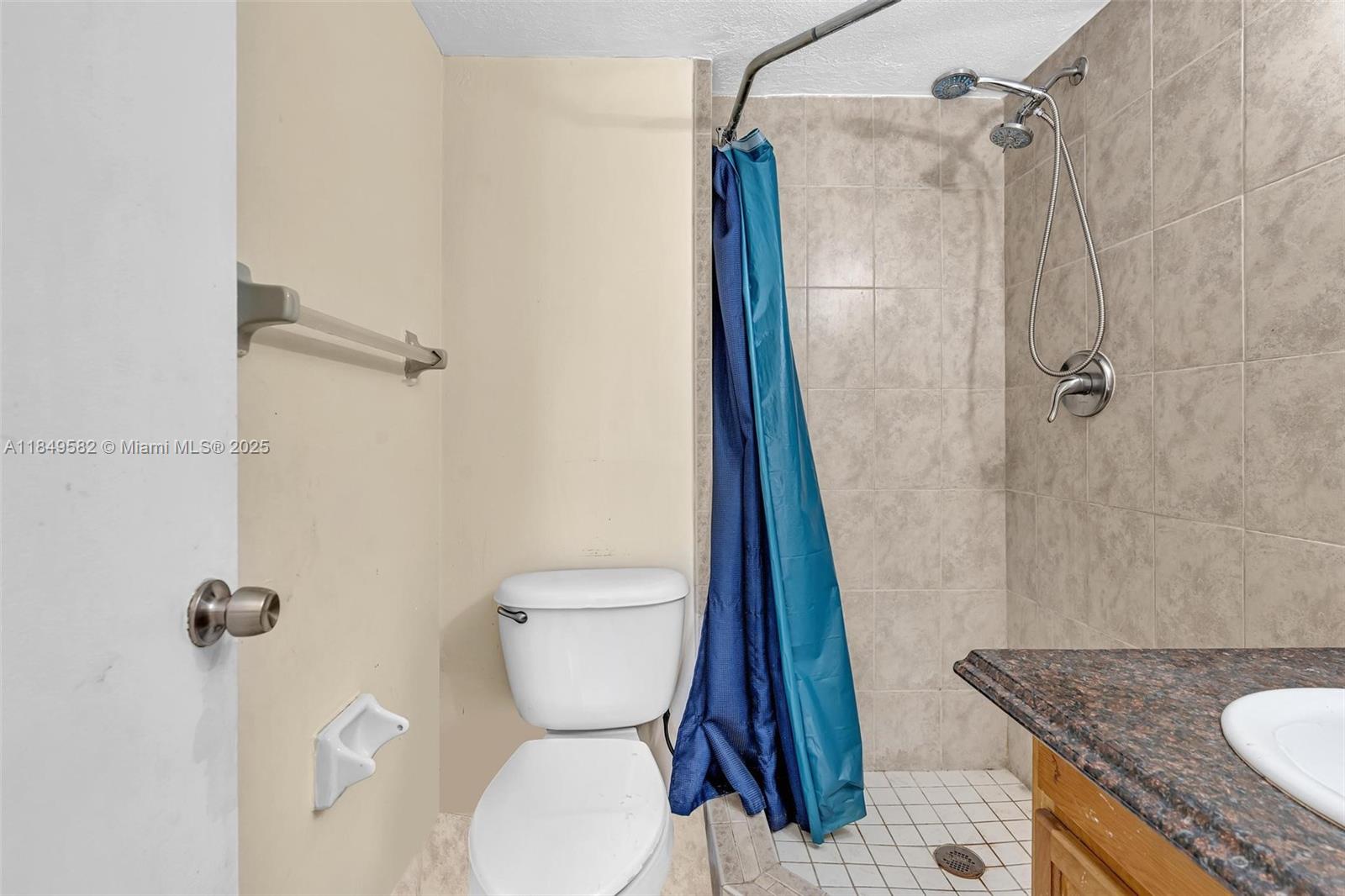 3750 Southwest 60th Terrace, Unit 1 Davie, FL 33314 - Photo 34 of 56 a bathroom with a granite countertop sink toilet and shower