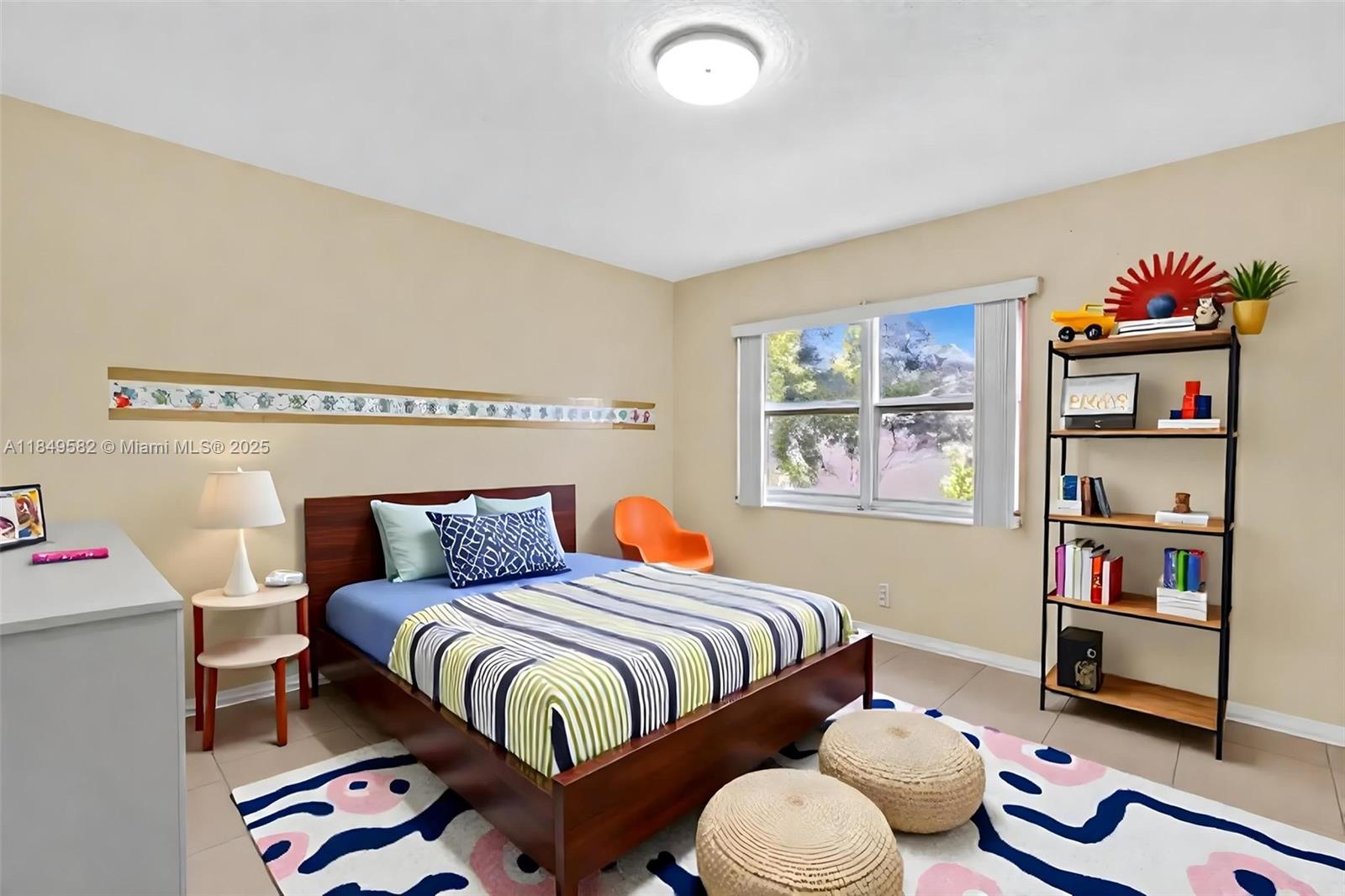 3750 Southwest 60th Terrace, Unit 1 Davie, FL 33314 - Photo 39 of 56 a bedroom with a bed and book shelf