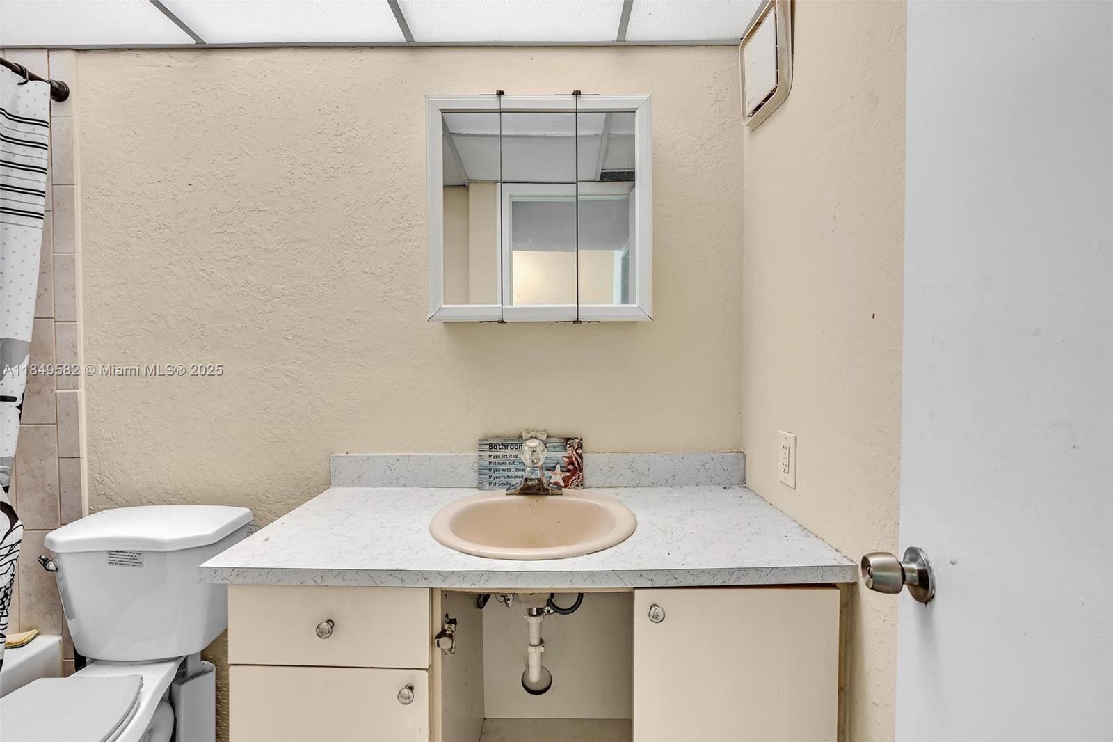 3750 Southwest 60th Terrace, Unit 1 Davie, FL 33314 - Photo 42 of 56 a bathroom with a sink toilet and a mirror