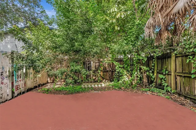 an aerial view of a house with a yard basket ball court and outdoor seating
