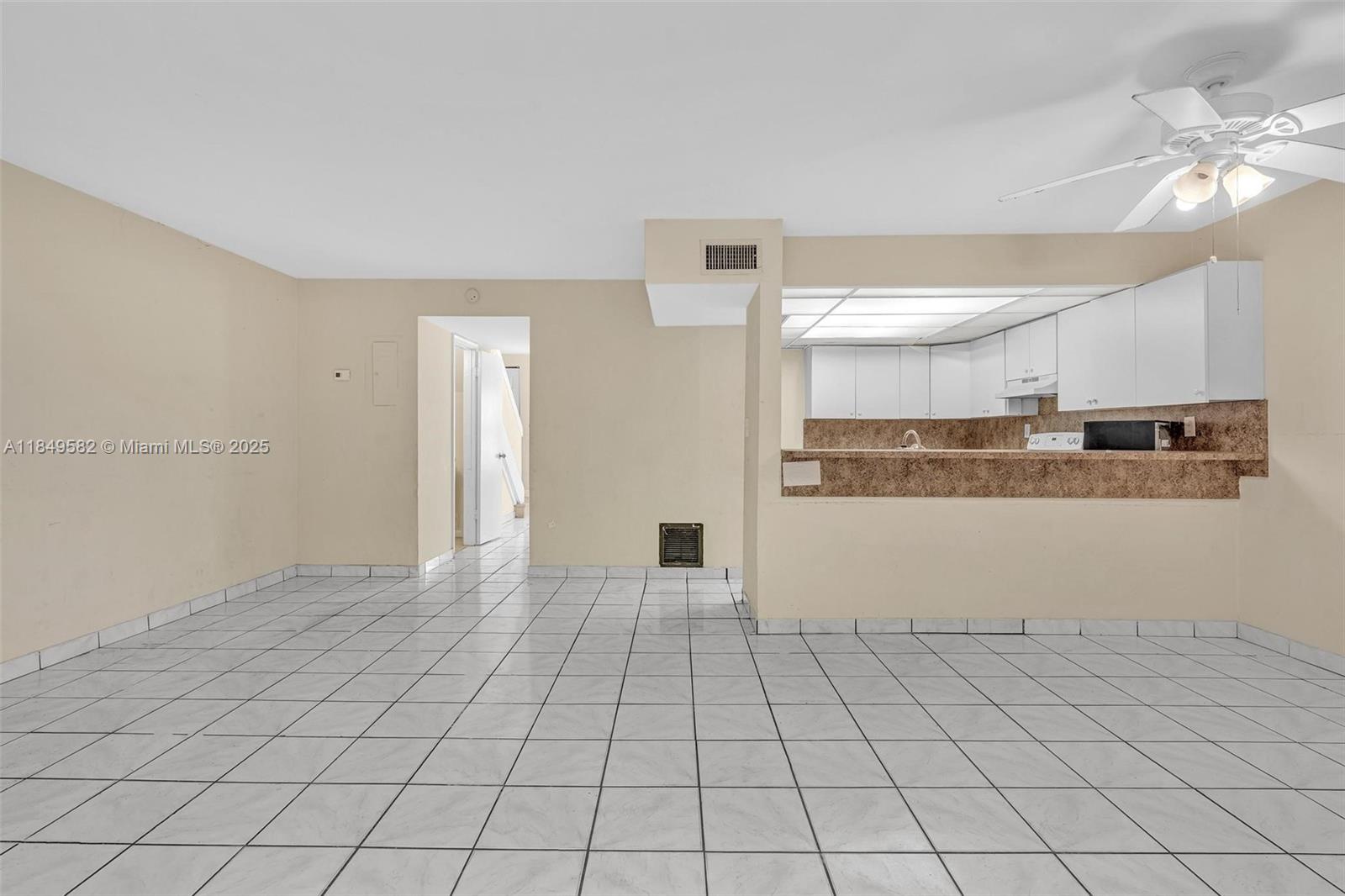 3750 Southwest 60th Terrace, Unit 1 Davie, FL 33314 - Photo 48 of 56 a view of a kitchen with wooden floor and a refrigerator
