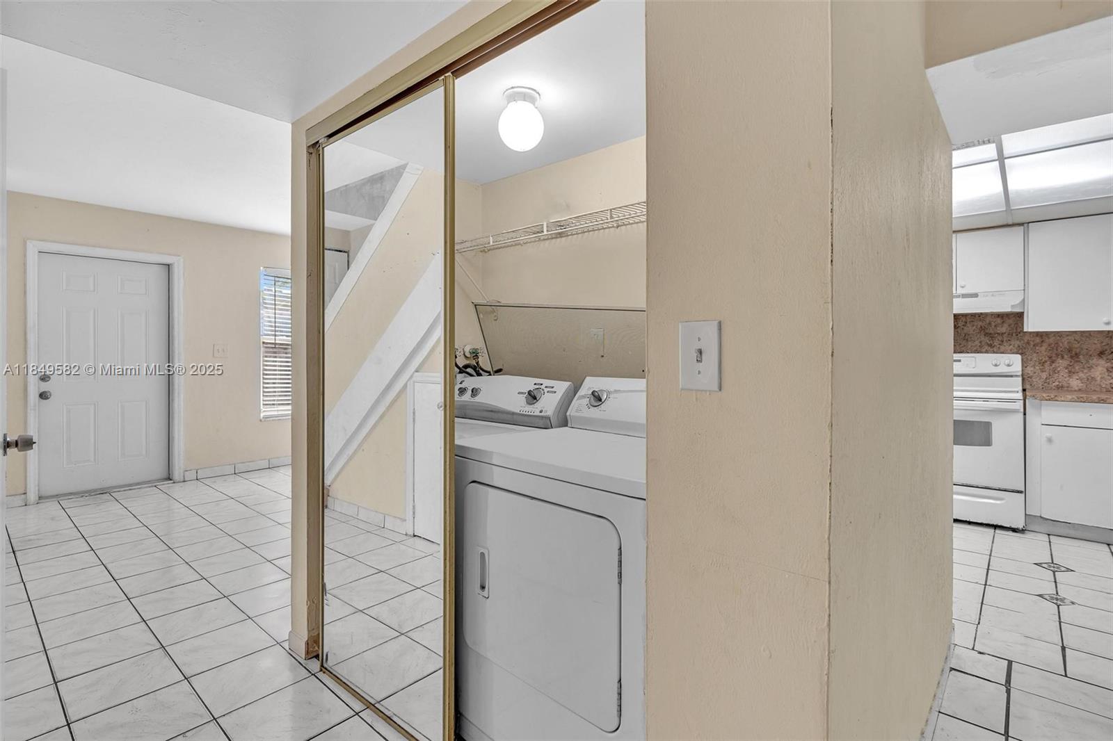 3750 Southwest 60th Terrace, Unit 1 Davie, FL 33314 - Photo 49 of 56 a utility room with cabinets washer and dryer