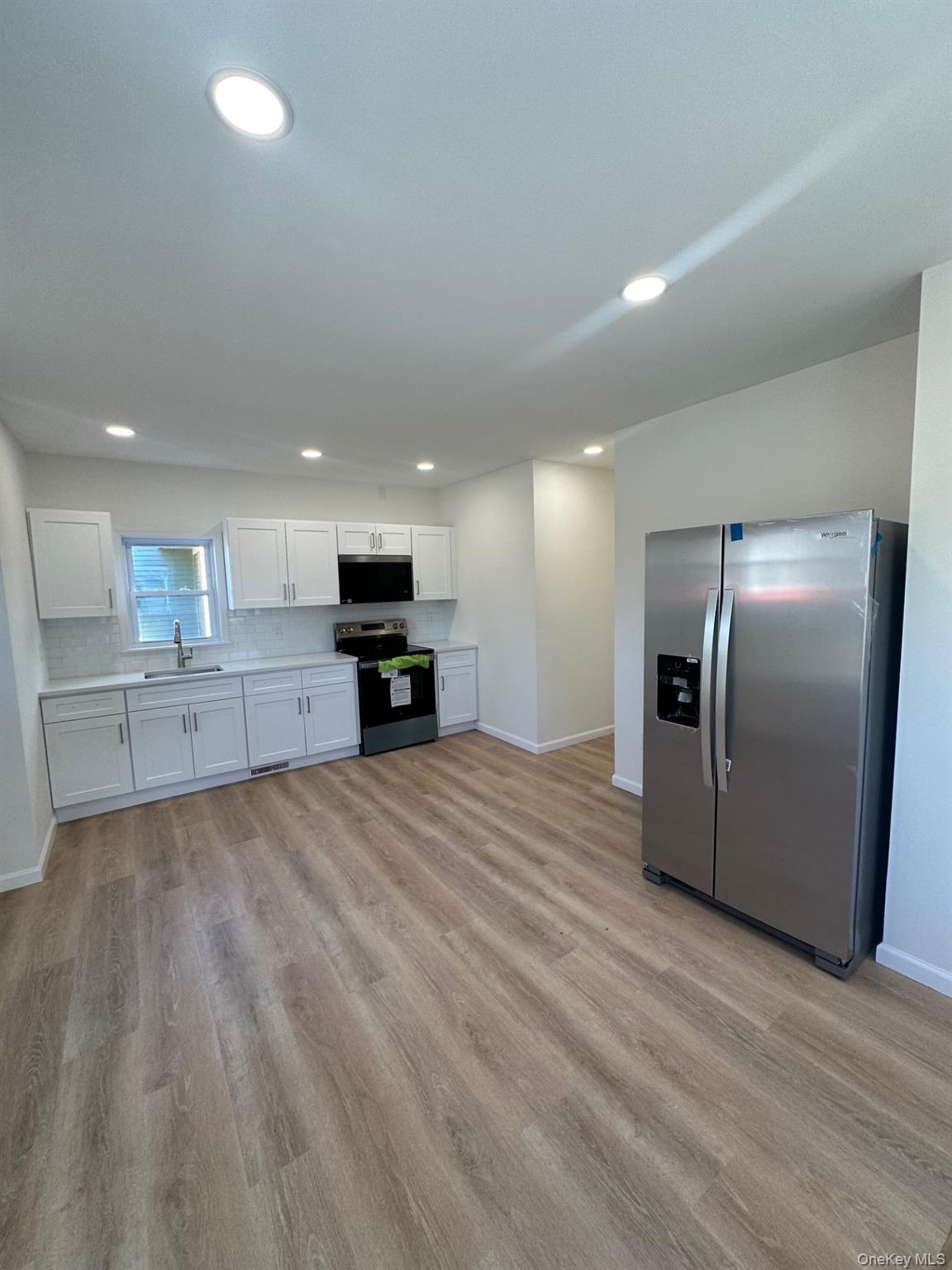 38 Carroll Street, Unit 1 Poughkeepsie, NY 12601 - Photo 1 of 1 a view of kitchen with stainless steel appliances kitchen island granite countertop a refrigerator and a stove top oven