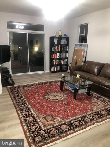 a living room with rug couches and a rug