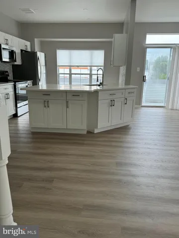 a view of a kitchen cabinets and a wooden floor