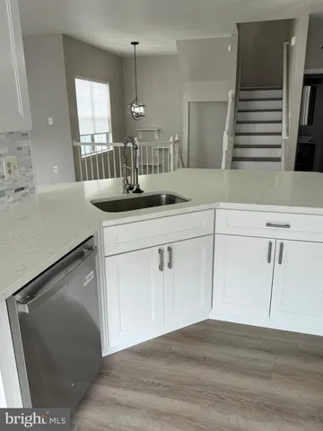 a kitchen with a sink and a mirror