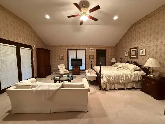 a bedroom with furniture and a flat screen tv
