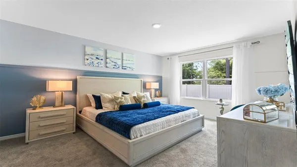 a bedroom with a large bed and a window