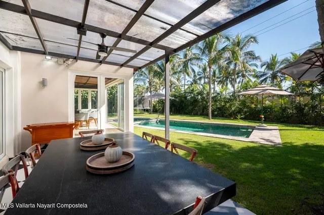 a view of a house with a yard porch and sitting area