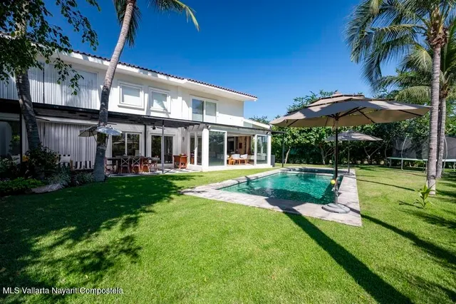 a kitchen with stainless steel appliances kitchen island granite countertop a refrigerator and a stove top oven