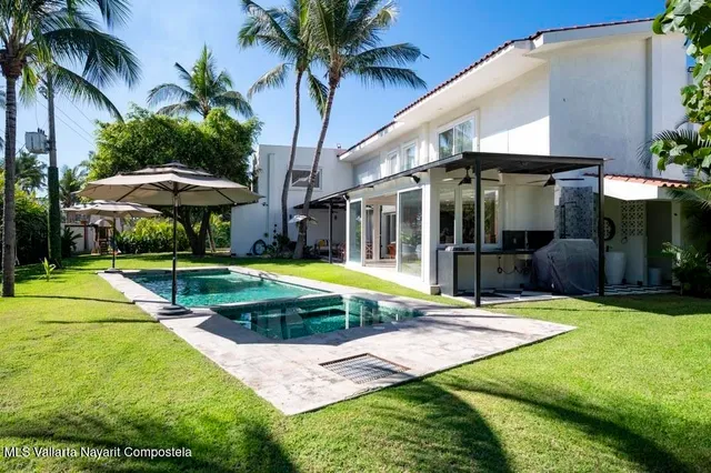 a kitchen with stainless steel appliances kitchen island granite countertop a stove and a refrigerator