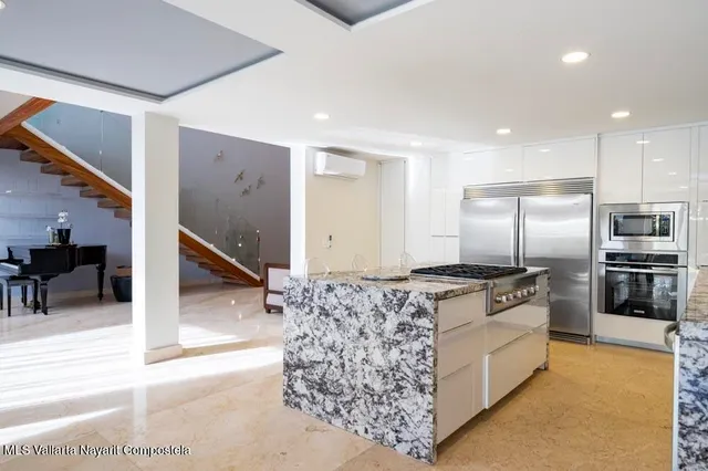 a bedroom with a bed and large glass window