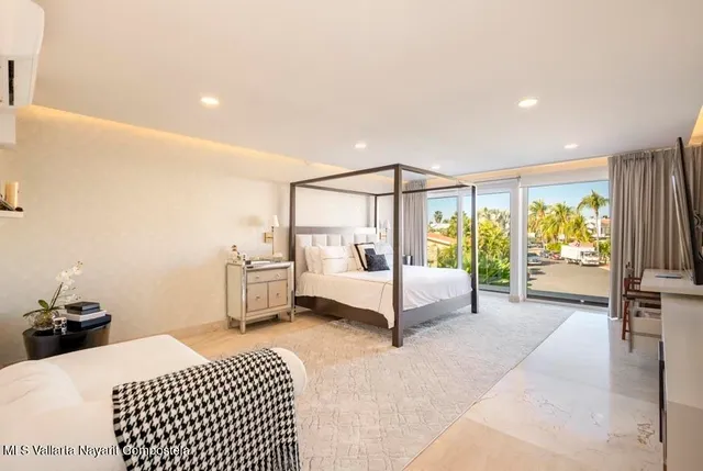 a bedroom with furniture and a flat screen tv