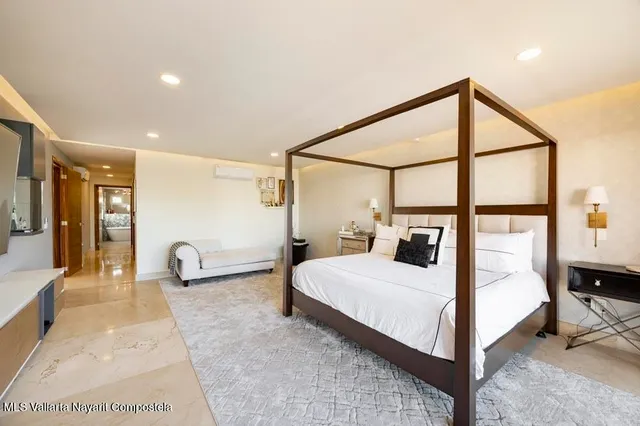 a bedroom with a large bed and a large window