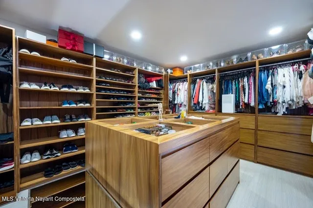 a bedroom with a bed and painting on the wall