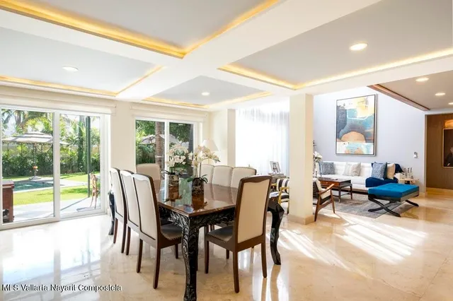 a living room with furniture a large window and table