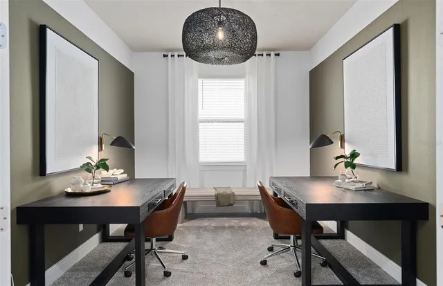 a view of a dining room with a table and chairs