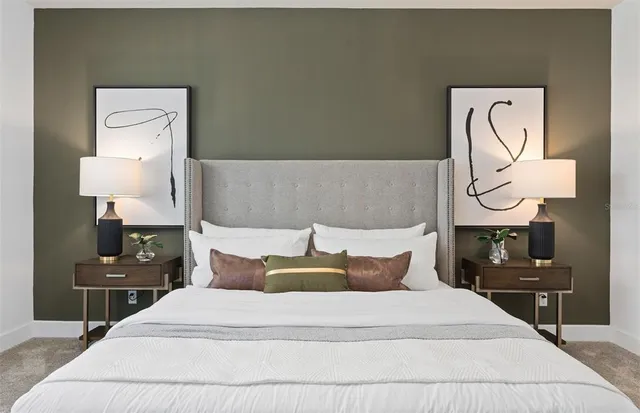 a bedroom with a bed and lamp on table