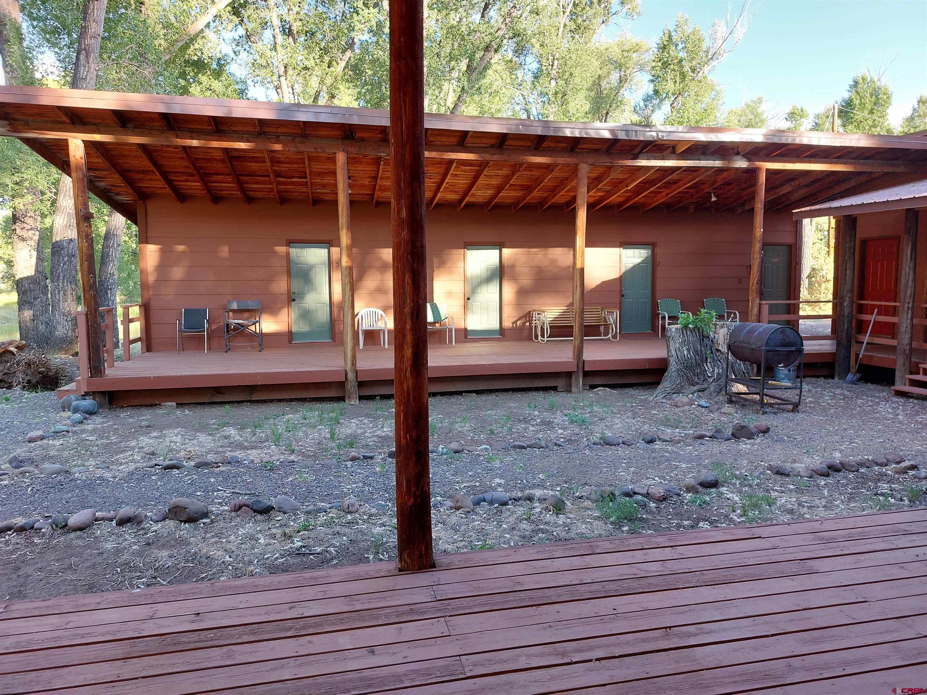 1 Conejos Trails Road Antonito, CO 81120 - Photo 11 of 20 a view of a backyard with table and chairs couches wooden floor and fence