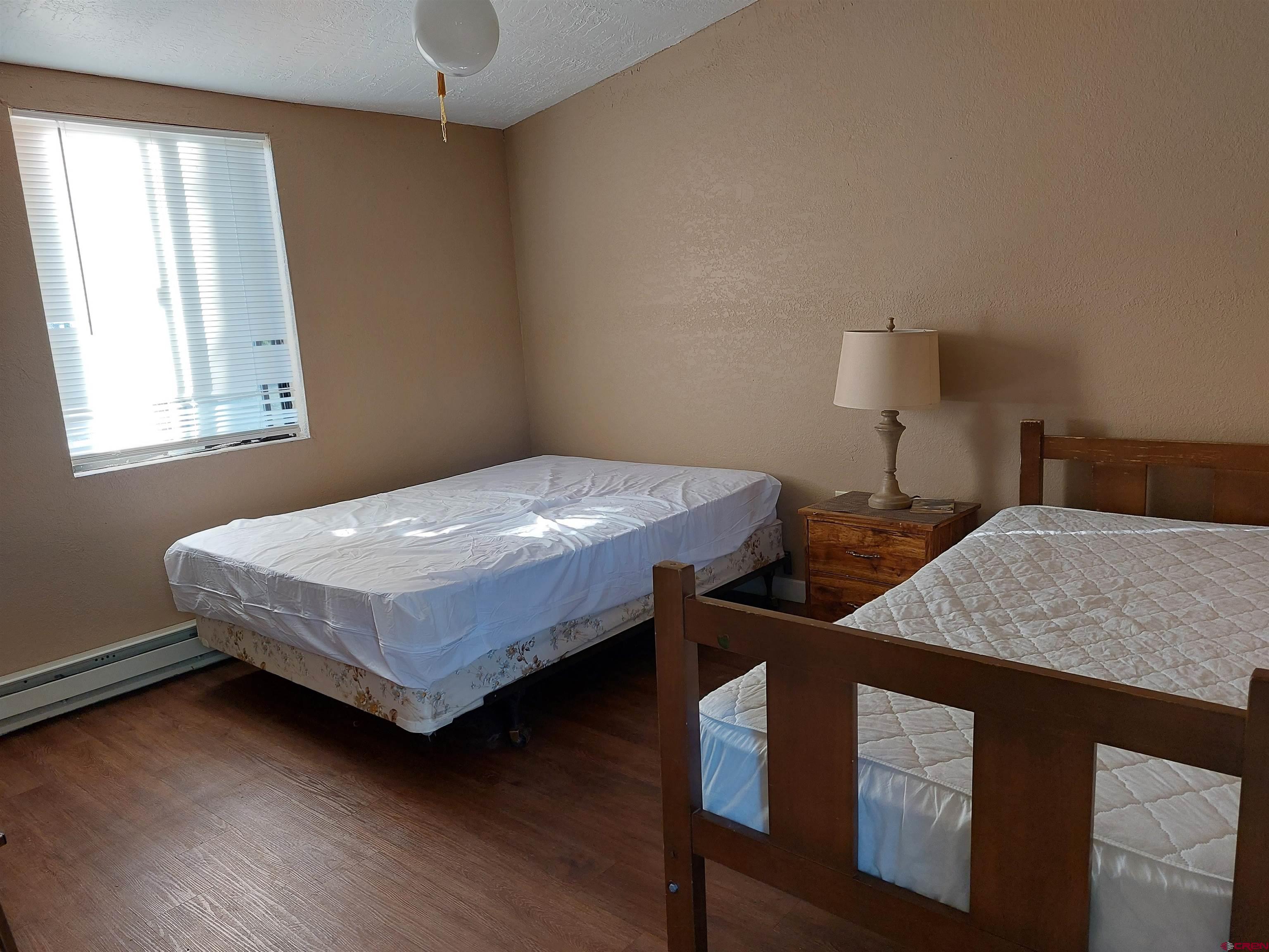 1 Conejos Trails Road Antonito, CO 81120 - Photo 17 of 20 a bedroom with a bed and a chandelier