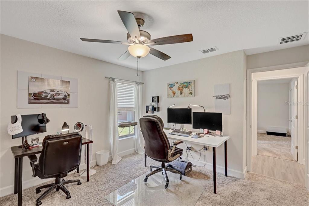 7314 Madrid Road Weeki Wachee, FL 34613 - Photo 29 of 54 a view of a workspace with furniture and a window