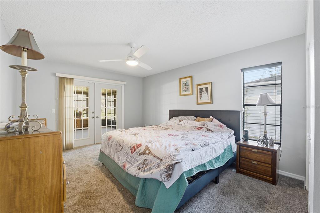 7822 Holiday Drive Spring Hill, FL 34606 - Photo 15 of 51 a bedroom with a bed and a chandelier