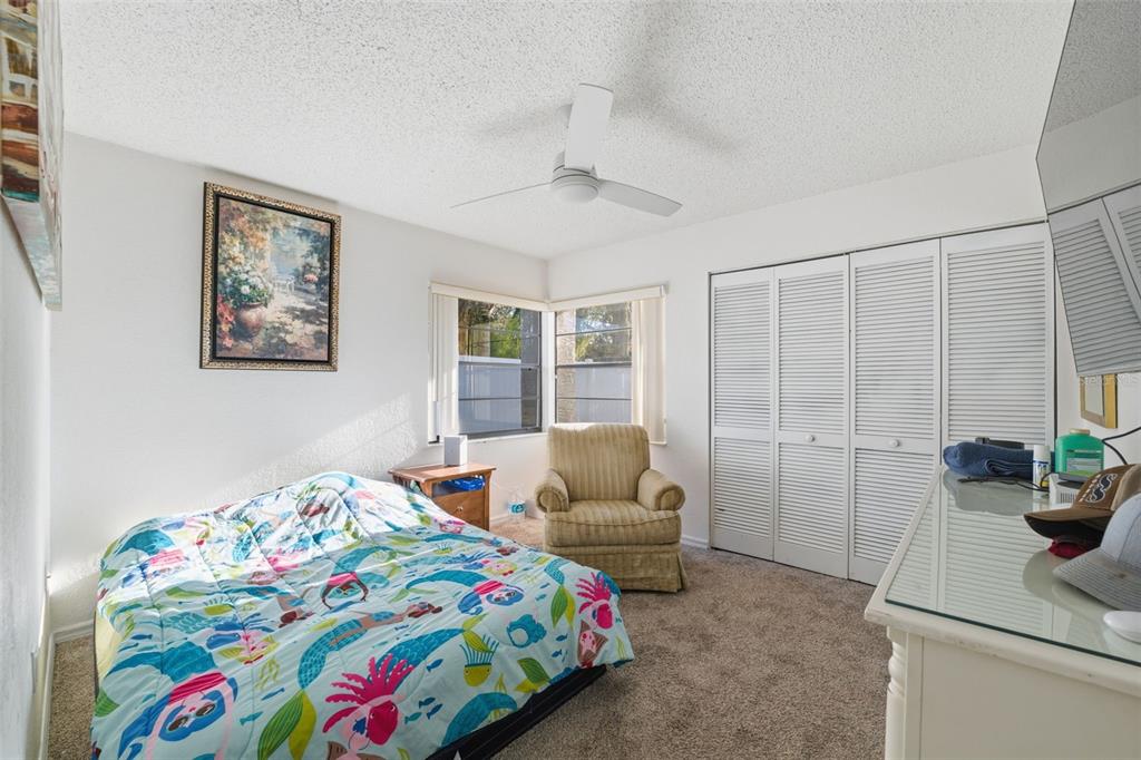 7822 Holiday Drive Spring Hill, FL 34606 - Photo 17 of 51 a bedroom that has a bed and a table in it