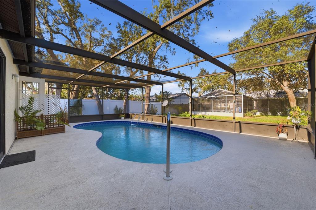 7822 Holiday Drive Spring Hill, FL 34606 - Photo 18 of 51 a view of a swimming pool with a yard