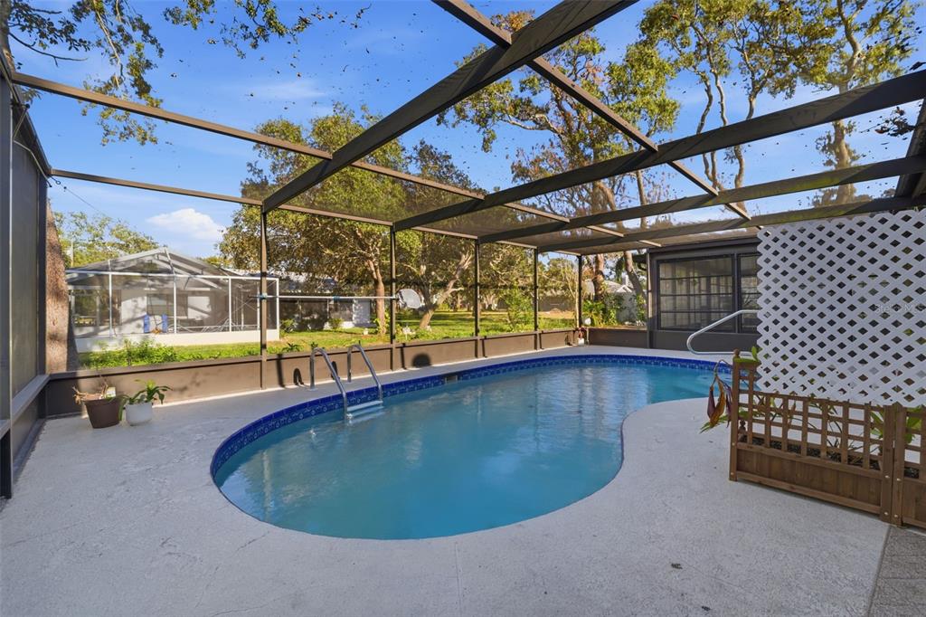 7822 Holiday Drive Spring Hill, FL 34606 - Photo 20 of 51 a view of a swimming pool with a patio