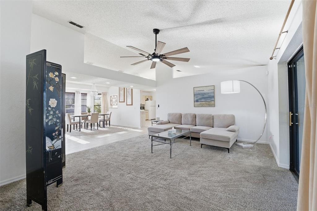 7822 Holiday Drive Spring Hill, FL 34606 - Photo 44 of 51 a living room with furniture and a chandelier