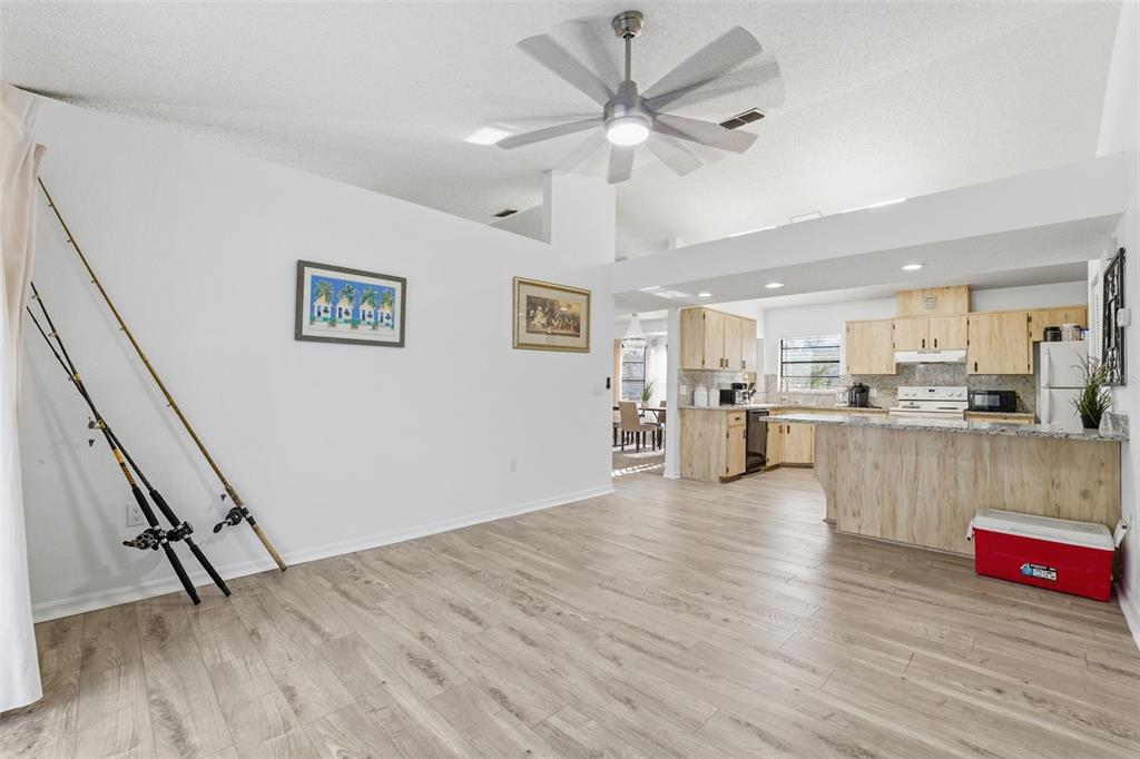 7822 Holiday Drive Spring Hill, FL 34606 - Photo 45 of 51 a view of a kitchen with furniture and wooden floor