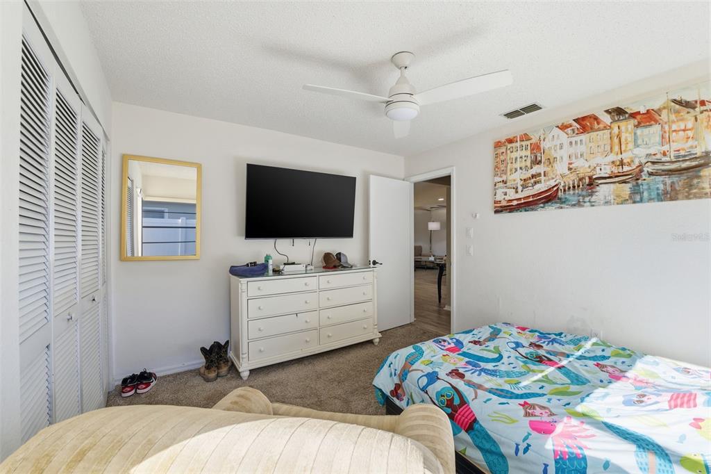 7822 Holiday Drive Spring Hill, FL 34606 - Photo 51 of 51 a bedroom with a bed and a flat screen tv