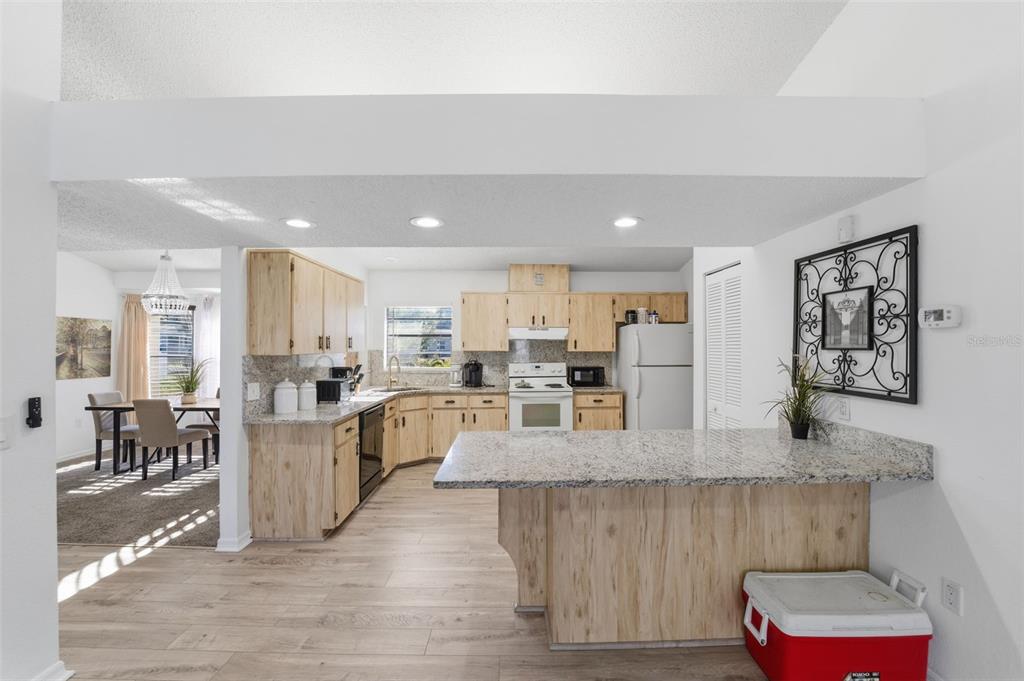 7822 Holiday Drive Spring Hill, FL 34606 - Photo 8 of 51 a large white kitchen with lots of counter space