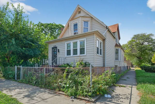 a front view of a house with plants