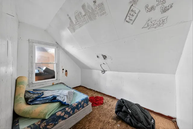 a bedroom with a bed and window