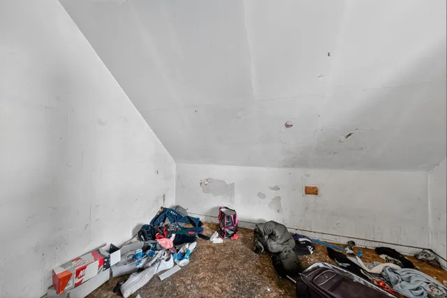 a room with gym equipment and a chandelier